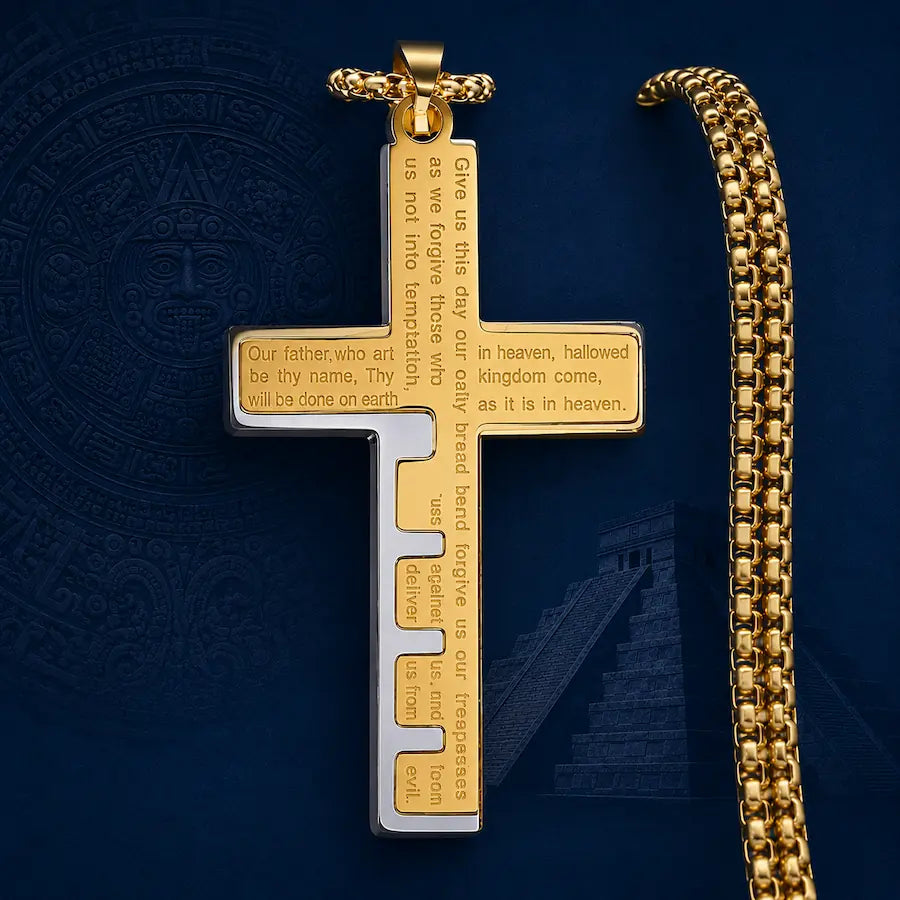 Cruz del Padre Nuestro Élite Luxe en acabados dorado y plata, presentada sobre un fondo azul texturizado que resalta el diseño y los detalles del grabado.